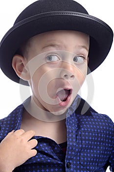 Cute little boy with bowler hat making faces