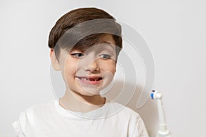 Cute little boy brushing teeth, isolated on white