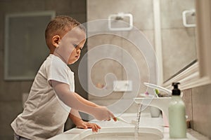 Cute Little Boy Brushing Teeth Side View