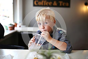 Cute Little Boy Child Drinking Drink at Cafe