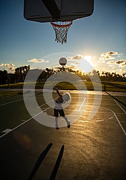 Cute little boy child jumping with basket ball for shot. Little child boy playing basketball. Active kids lifestyle