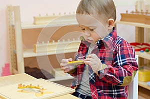 Cute little boy in the classroom early development.