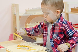 Cute little boy in the classroom early development.