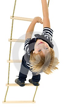 Cute little boy climbing rope ladder