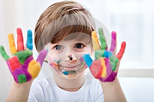 Cute little boy with colored hands