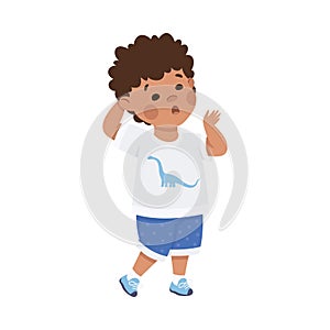 Cute little boy with confused face expression. Puzzled dark haired curly boy dressed white t-shirt and blue shorts