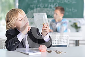 Cute little boy counting money