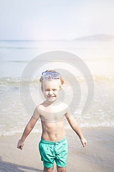 Cute little boy with diving glasses at the beach, thailand