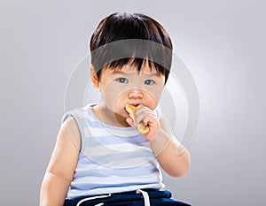 Cute little boy eating cookie