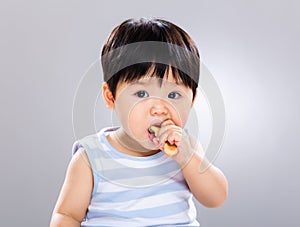 Cute little boy eating cookie