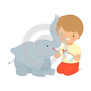 Cute Little Boy Feeding Baby Elephant with Milk Bottle, Adorable Kid Caring for Animal Cartoon Vector Illustration