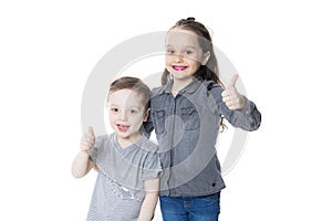 Cute little boy and girl with his thumb up on the white background