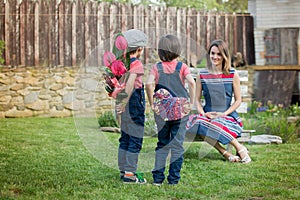 Cute little boy, giving present to his mom for Mothers day