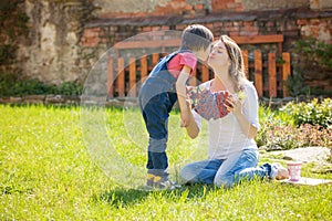 Cute little boy, giving present to his mom for Mothers day