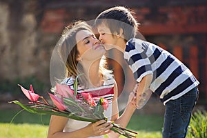 Cute little boy, giving present to his mom for Mothers day