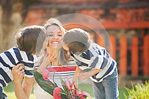 Cute little boy, giving present to his mom for Mothers day