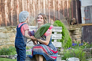 Cute little boy, giving present to his mom for Mothers day