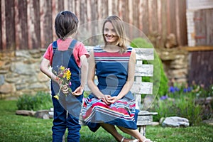 Cute little boy, giving present to his mom for Mothers day