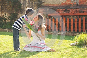 Cute little boy, giving present to his mom for Mothers day