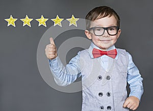 Cute little boy giving thumbs up with 5 stars approved