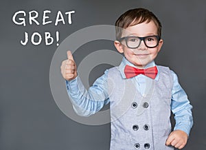 Cute little boy giving thumbs up saying Great Job