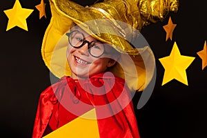 Cute little boy in glasses and sky watcher costume