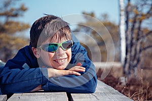 Cute little boy having rest outdoors on beautiful spring day photo