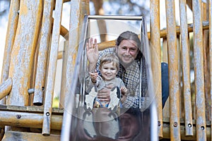 Cute little boy and his father on the playground