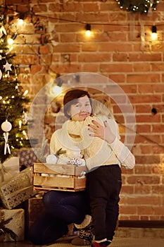 Cute little boy and his mother or grandmother on Christmas eve