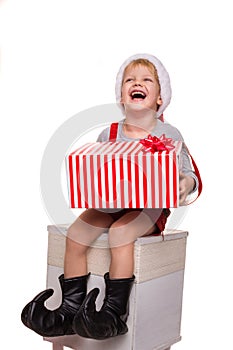 Cute little boy holding big present and laugh. Christmas concept