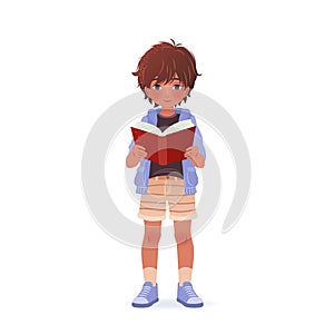 Cute little boy is holding book in his hands and reading it.