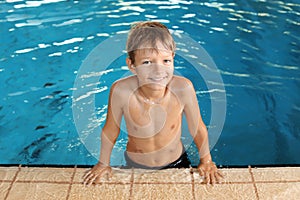 Cute little boy in indoor pool