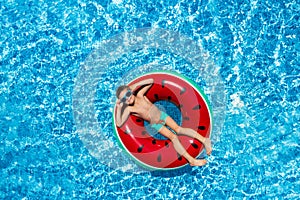 Cute little boy with inflatable ring in swimming pool. Summer vacation