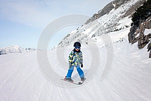 Cute little boy, learning to ski in Austrian ski resort