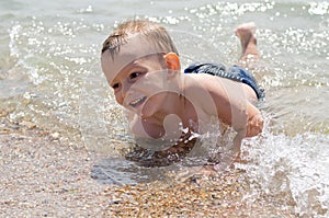 Cute little boy learning to swim