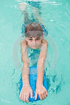 Cute little boy learning to swim