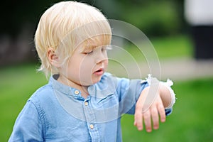 Cute little boy looking on his elbow with applied bandage