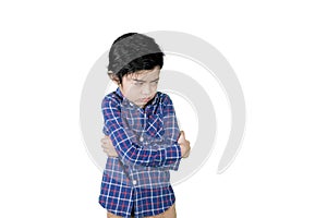 Cute little boy looks cranky in the studio