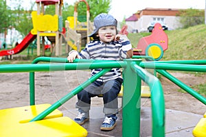 Cute little boy on merry-go-round