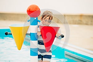 Cute little boy playing in baby pool