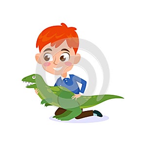 A cute little boy playing with a big dinosaur toy isolated on white background