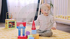 cute little boy playing with blocks in the children's room