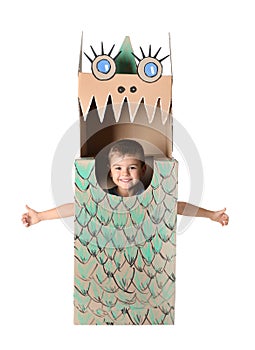 Cute little boy playing with cardboard dragon