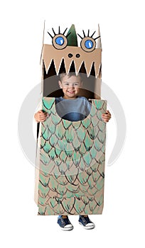 Cute little boy playing with cardboard dragon