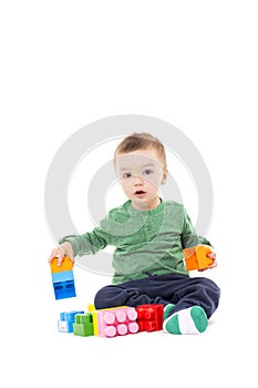 Cute little boy playing with colorful blocks