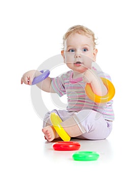 Cute little boy playing colorful toys