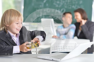 Cute little boy playing computer games