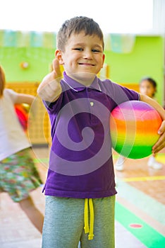 Cute little boy playing at daycare gym photo