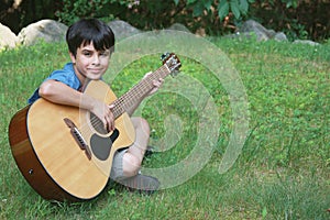 Cute Little Boy Playing Guitar