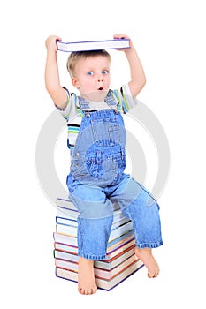 Cute little boy is reading a book